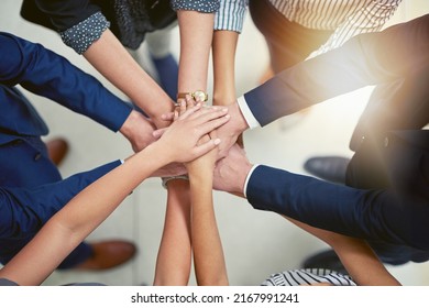 Making Business Better Together. Closeup Shot Of A Group Of Businesspeople Joining Their Hands Together In Unity.