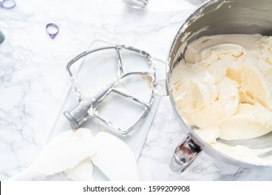 Making buttercream frosting for decorating a vanilla cake.