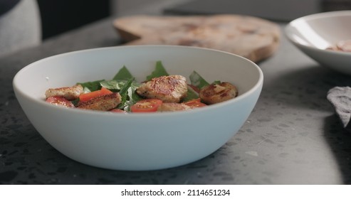 Making Caesar Salad In White Bowl , Put Chicken Pieces