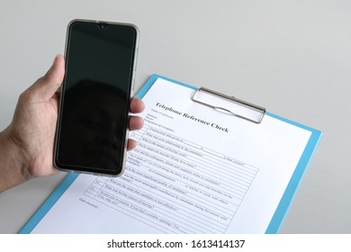 Making A Call To Conduct A Telephone Reference Check On A Potential Employee