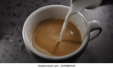 Making Cappuccino, Pour Steamed Milk Into White Cup With Espresso, Wide Photo