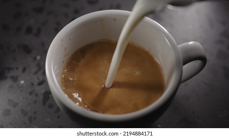 Making Cappuccino, Pour Steamed Milk Into White Cup With Espresso, Wide Photo