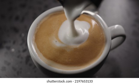 Making Cappuccino, Pour Steamed Milk Into White Cup With Espresso