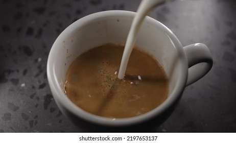 Making Cappuccino, Pour Steamed Milk Into White Cup With Espresso