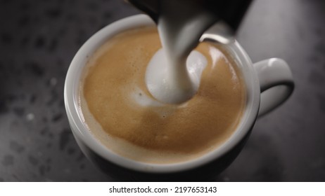 Making Cappuccino, Pour Steamed Milk Into White Cup With Espresso