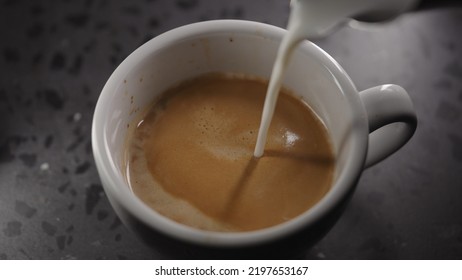 Making Cappuccino, Pour Steamed Milk Into White Cup With Espresso