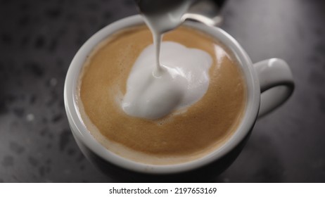 Making Cappuccino, Pour Steamed Milk Into White Cup With Espresso