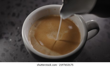 Making Cappuccino, Pour Steamed Milk Into White Cup With Espresso