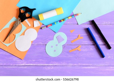 Making A Children Winter Paper Card. Step. Snowman Parts Cut From Paper, Scissors, Markers, Pencil, Glue Stick, Colored Paper Set, Snowman Templates On Wooden Table. Kids Winter DIY Project. Top View