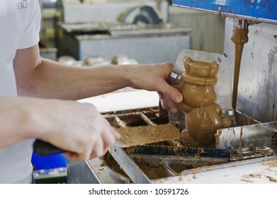 Making Chocolate Bunny In A Bakery. Close-up Of Hands.