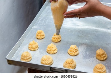 The making of choux pastry: close up view of raw choux pastry dough piped  onto a tin pan, selective focus - Powered by Shutterstock