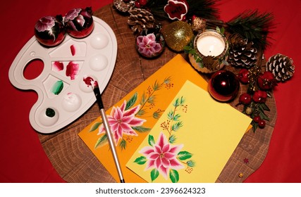 Making Christmas cards painting with colors, card, paint  brush and Christmas decoration
