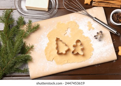 Making Christmas cookies. Flat lay composition with cutters and raw dough on wooden table - Powered by Shutterstock