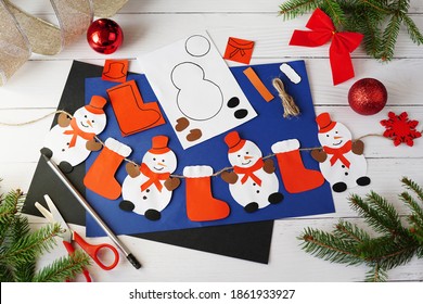 Making Christmas Garland With Snowmans From Paper. Children's Art Project. DIY Concept. Photo Instruction