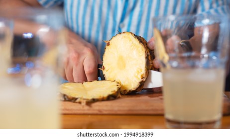 Making A Cocktail Step By Step. Step One: Cutting The Pineapple. Bartender And Mixologist Preparing Ingredients At Home