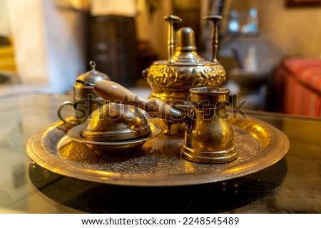 Making coffee according to an old Arabic recipe. metal copper objects for making coffee on the table