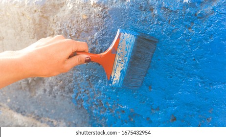 Making Community Service Painting A Wall With Blue