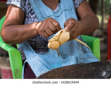 Making Cooking Rustic Homemade Corn Maize Tamale With Yellow Leaf Husk In Blue Apron  