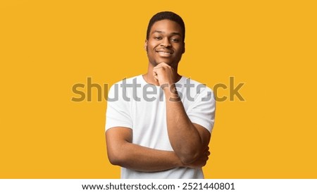 Making Decision. Thoughtful black guy looking at camera, holding hand on chin, panorama, orange wall, copyspace
