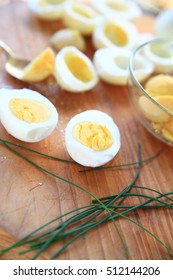 Making Deviled Eggs With Chives On Cutting Board