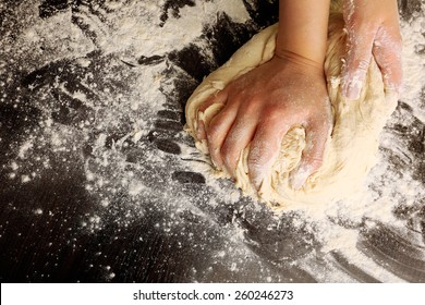 Making dough by female hands on wooden table background - Powered by Shutterstock