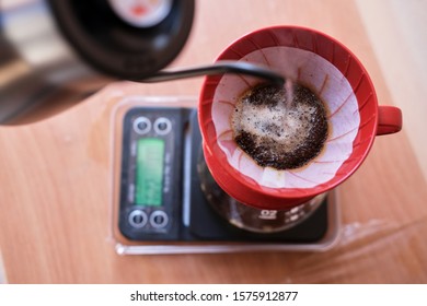 Making A Drip Coffee Using Red Filter And Black Kettle In The Afternoon