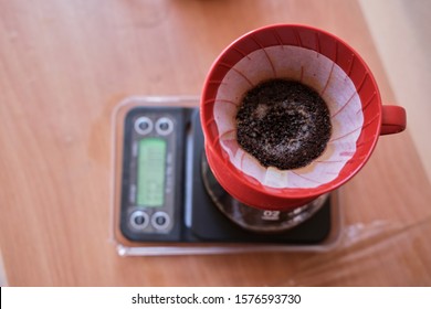 Making A Drip Coffee Using Red Filter And Black Kettle In The Afternoon