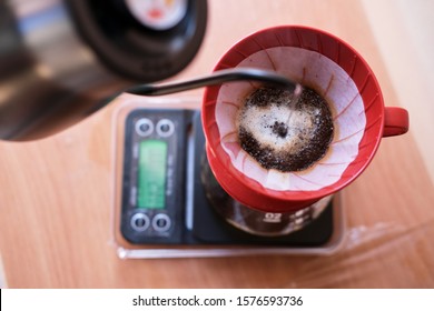 Making A Drip Coffee Using Red Filter And Black Kettle In The Afternoon