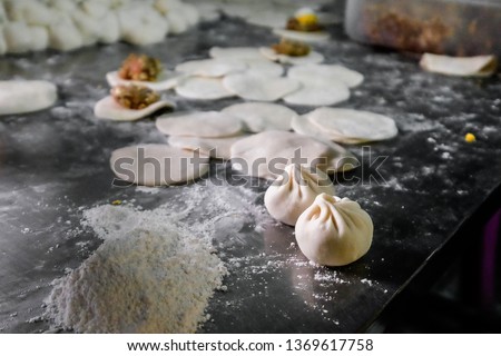 Making of Dumpling, Dimsum, Bao, a Chinese Steam bun with ingredients on the table.