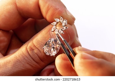 Making earrings. Closeup hands of jeweler at work in jewelry. Desktop for craft jewelry making with professional tools. Concept of job, business, beauty, art and ad. - Shutterstock ID 2202718613