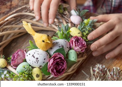 Making Of Easter DIY Wreath With Eggs And Flowers, Composition On Rustic Wooden Table 