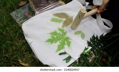 making ecoprinting using green leaves and fabric to make leaves pattern on a goodie bag - Shutterstock ID 2140024967