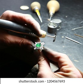 Making a emerald diamond ring in a jewelery workshop - Shutterstock ID 1204567693