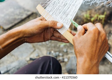 Making a fishnet, selective focus on left hand