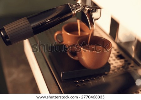 Making fresh aromatic coffee using espresso machine in cafe, closeup