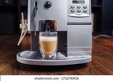 Making Fresh Coffee Going Out From A Coffee Espresso Machine. Making Capuccino In Glass Transparent Coffee Cup. Budget Coffee Maker