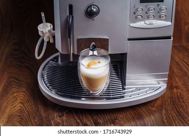 Making Fresh Coffee Going Out From A Coffee Espresso Machine. Making Capuccino In Glass Transparent Coffee Cup. Budget Coffee Maker