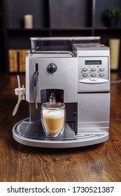 Making Fresh Coffee Going Out From A Coffee Espresso Machine. Making Capuccino In Glass Transparent Coffee Cup. Budget Coffee Maker