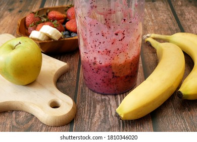 Making Fruit Smoothie With Banana, Blueberry, Strawberry And Milk. Blender Filled With Fresh Whole Fruits For Making A Smoothie 