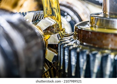 Making gears on a gear cutting machine. Machine oil cools the cutting process of the gear wheel with a modular cutter. - Shutterstock ID 2107989521