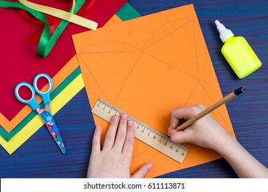 Making A Gift Box By The Child. Children's Art Project. DIY Concept. Step-by-step Photo Instruction. Step 2. Child Is Making Drawing Of A Box