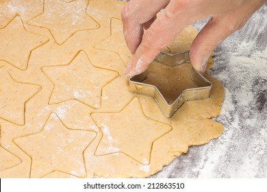 Making gingerbread christmas cookies with metal cutter. Ginger dough and flour