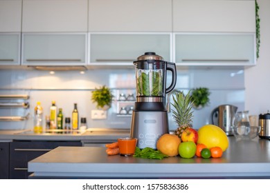 Making green smoothies with blenderat home in kitchen, healthy eating lifestyle concept - Powered by Shutterstock