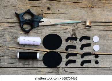 Making A Halloween Felt Spider Decoration. Cut Black And White Felt Details To Create Halloween Spider Toy. Step. Craft Supplies On A Wooden Table. Halloween Spider Crafts Tutorial For Kids. Top View