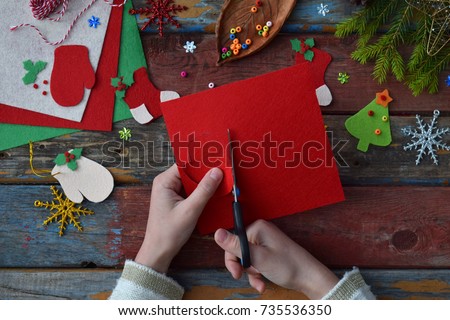 Making of handmade christmas toys from felt with your own hands. Children's DIY concept. Making xmas tree decoration or greeting card. Step 2. Cut the toy
