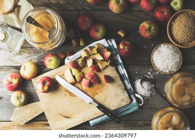 Making homemade apple cider vinegar, preperation. Apples, salt, sugar on trustic wooden table. CHopped apples on cutting board.