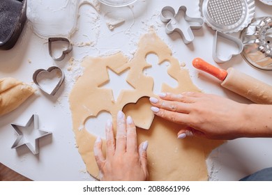 Making for homemade biscuits. On the table is dough and a set of cookie molds with other kitchen equipment. Cute baby cookies in the shape of a person, a heart and a star. Cooking with baking tools. - Powered by Shutterstock