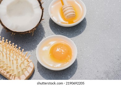 Making homemade hair mask with natural ingredients - egg yolk, herbal honey and coconut oil. Natural hair beauty treatment. Zero waste handmade cosmetics
