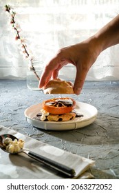 Making Homemade Holiday Cookies With Chocolate Cream And Candied Citrus With Popcorn. Woman's Hand Puts Bize On Shortbread Cookies.