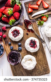 Making Homemade Pavlova Dessert With Berry Fruits, View From Overhead, On Wooden Kitchen Table